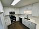 Updated kitchen boasts white cabinets, stainless steel appliances, and ample counter space for meal preparation at 208 Arbour Way, Suwanee, GA 30024