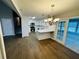 Bright kitchen boasts white cabinets, stainless steel appliances, and elegant hardwood flooring throughout at 208 Arbour Way, Suwanee, GA 30024