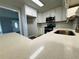 Gourmet kitchen features stainless steel appliances, white cabinets, and gleaming countertops at 208 Arbour Way, Suwanee, GA 30024