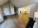 Open concept living room features hardwood floors and opens to the kitchen with an eat-in bar at 208 Arbour Way, Suwanee, GA 30024