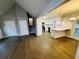 Open concept living room features hardwood floors and opens to the kitchen with an eat-in bar at 208 Arbour Way, Suwanee, GA 30024