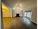 Bright living room featuring hardwood floors, fireplace, and large windows allowing for natural light at 208 Arbour Way, Suwanee, GA 30024