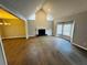 Open living room with hardwood floors, fireplace, and vaulted ceiling at 208 Arbour Way, Suwanee, GA 30024