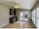 Sunroom with a wet bar, ceiling fan, and multiple windows at 208 Arbour Way, Suwanee, GA 30024