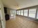 Light-filled sunroom with tile floors, ceiling fan, and views of the backyard at 208 Arbour Way, Suwanee, GA 30024