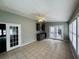Spacious sunroom with a wet bar area and double doors to the exterior at 208 Arbour Way, Suwanee, GA 30024