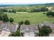 Aerial view of neighborhood homes with golf course and lush greenery creating a serene residential setting at 214 Misty View Dr, Canton, GA 30114