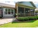 A well-maintained backyard has a screened-in porch, a stone patio, and lush lawn at 214 Misty View Dr, Canton, GA 30114
