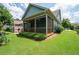 Exterior view of a home with a screened-in porch, surrounded by a well-kept lawn at 214 Misty View Dr, Canton, GA 30114