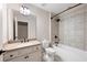 Bright bathroom featuring a tiled shower over tub, neutral counter tops, and classic vanity at 214 Misty View Dr, Canton, GA 30114