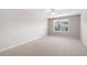 This bedroom has neutral walls, carpet, a ceiling fan, and a window bringing in lots of light at 214 Misty View Dr, Canton, GA 30114