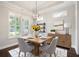 Elegant dining room features a modern chandelier, plantation shutters, and stylish decor at 214 Misty View Dr, Canton, GA 30114
