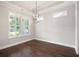 Bright dining room with hardwood floors, plantation shutters, modern lighting, and a tray ceiling at 214 Misty View Dr, Canton, GA 30114