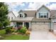 Charming two-story home featuring a well-manicured lawn and a two-car garage at 214 Misty View Dr, Canton, GA 30114