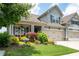 Beautiful two-story home with manicured lawn, inviting front porch, and two-car garage at 214 Misty View Dr, Canton, GA 30114