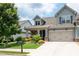 Inviting two-story home featuring manicured landscaping, a porch, and an attached two-car garage at 214 Misty View Dr, Canton, GA 30114