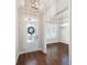 Inviting foyer featuring dark hardwood floors, a decorative wreath, and an adjacent dining room at 214 Misty View Dr, Canton, GA 30114