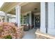 Inviting front porch featuring stone accents, a seating area, and a decorative wreath on the door at 214 Misty View Dr, Canton, GA 30114