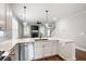 Kitchen island with stainless steel dishwasher and sink overlooks living room with stone fireplace at 214 Misty View Dr, Canton, GA 30114
