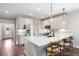 Kitchen area with white cabinets, stainless steel appliances, island, and eat-in barstools at 214 Misty View Dr, Canton, GA 30114