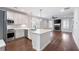 Bright, modern kitchen with white cabinets, stainless steel appliances, and an island with quartz countertops at 214 Misty View Dr, Canton, GA 30114