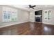 Living room featuring a stone fireplace, ceiling fan, and plantation shutters at 214 Misty View Dr, Canton, GA 30114