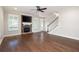 Living room featuring a stone fireplace, ceiling fan, and stairway access at 214 Misty View Dr, Canton, GA 30114