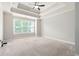 Spacious main bedroom with plush carpeting, tray ceilings, and large windows offering plenty of light at 214 Misty View Dr, Canton, GA 30114