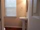 Small bathroom featuring pedestal sink and window at 2199 Landing Walk Dr, Duluth, GA 30097