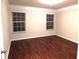 Bright bedroom features hardwood floors, crown molding, and multiple windows at 2199 Landing Walk Dr, Duluth, GA 30097