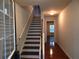 A lovely home entryway with beautiful wood floors and stairs with white railing at 2199 Landing Walk Dr, Duluth, GA 30097