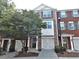 Brick townhome with symmetrical window design, manicured lawn, and covered entryway at 2199 Landing Walk Dr, Duluth, GA 30097