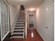 Bright hallway with hardwood floors and staircase leading to the upper level at 2199 Landing Walk Dr, Duluth, GA 30097