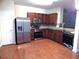 Well-equipped kitchen with stainless steel appliances, wooden cabinets, and hardwood floors at 2199 Landing Walk Dr, Duluth, GA 30097
