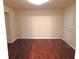 Living area with hardwood floors, neutral walls, and a door leading outside at 2199 Landing Walk Dr, Duluth, GA 30097