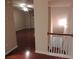 Spacious living room with gleaming hardwood floors and staircase with white balusters at 2199 Landing Walk Dr, Duluth, GA 30097