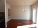 Open living room with hardwood floors, chandelier, and staircase at 2199 Landing Walk Dr, Duluth, GA 30097
