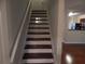Staircase leading to an upper level, adjacent to kitchen area at 2199 Landing Walk Dr, Duluth, GA 30097