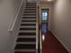 Staircase with wood treads and white risers, leading to upper level with hardwood floors at 2199 Landing Walk Dr, Duluth, GA 30097