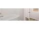 Bright bathroom with a white bathtub, modern fixtures, and a view from the window at 321 Sound Cir, Stockbridge, GA 30281