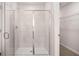Contemporary bathroom with a glass-enclosed shower, updated fixtures, and walk-in closet at 321 Sound Cir, Stockbridge, GA 30281