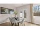 Dining room showcases a modern table for six, two art paintings, and a door to the outdoor living space at 321 Sound Cir, Stockbridge, GA 30281