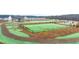 Aerial view of the community dog park with lush green lawns, walking path and benches at 321 Sound Cir, Stockbridge, GA 30281