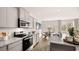 Modern kitchen with gray cabinets, granite countertops, and stainless steel appliances at 321 Sound Cir, Stockbridge, GA 30281