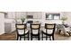 Modern kitchen features gray cabinets, granite countertops, stainless steel appliances, and hardwood floors at 321 Sound Cir, Stockbridge, GA 30281