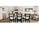 Stylish kitchen with stainless steel appliances, granite countertops, and barstool seating at the center island at 321 Sound Cir, Stockbridge, GA 30281