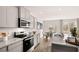 Modern kitchen features gray cabinets, granite countertops, stainless steel appliances, and hardwood floors at 321 Sound Cir, Stockbridge, GA 30281