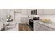 Modern kitchen features granite countertops, stainless steel appliances, and gray cabinetry at 321 Sound Cir, Stockbridge, GA 30281