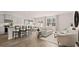 Open-concept kitchen, dining, and living space featuring light finishes, modern decor, and ample natural light at 321 Sound Cir, Stockbridge, GA 30281