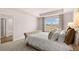 Spacious main bedroom featuring a tray ceiling, plush carpeting, and natural light at 321 Sound Cir, Stockbridge, GA 30281